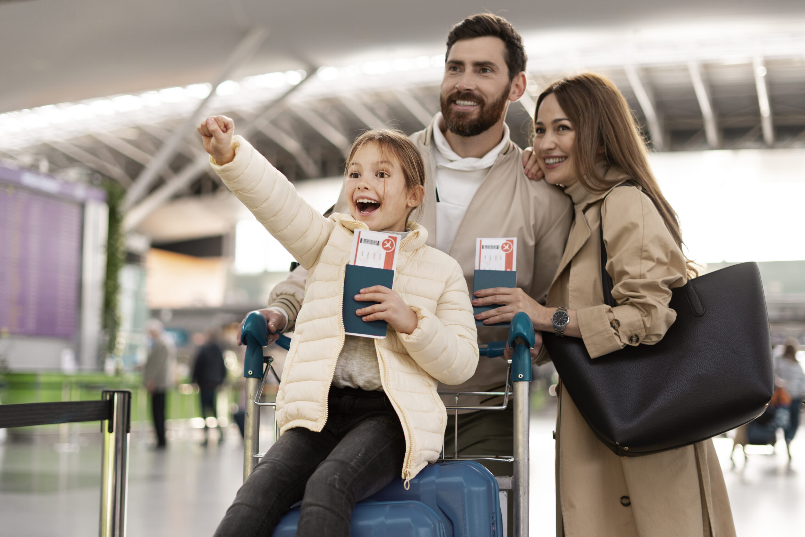 Family sponsorship to Canada – happy family at airport with luggage after reunification