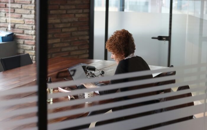 Entrepreneur immigration Canada applicant preparing business documents in a modern office.