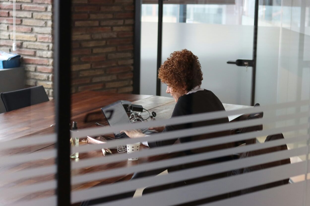 mert-cetin-OsuqKf-RG4A-unsplash Entrepreneur immigration Canada applicant preparing business documents in a modern office.