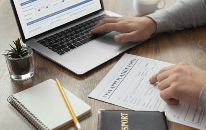Person reviewing visa application form on laptop with notebook and pen – immigration appeal process Canada